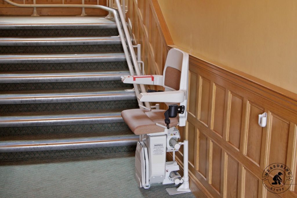 stairlift installed on staircase with wooden wall