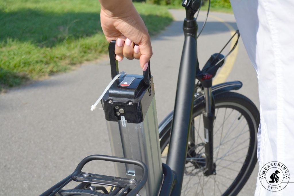 woman removing an electric bike battery