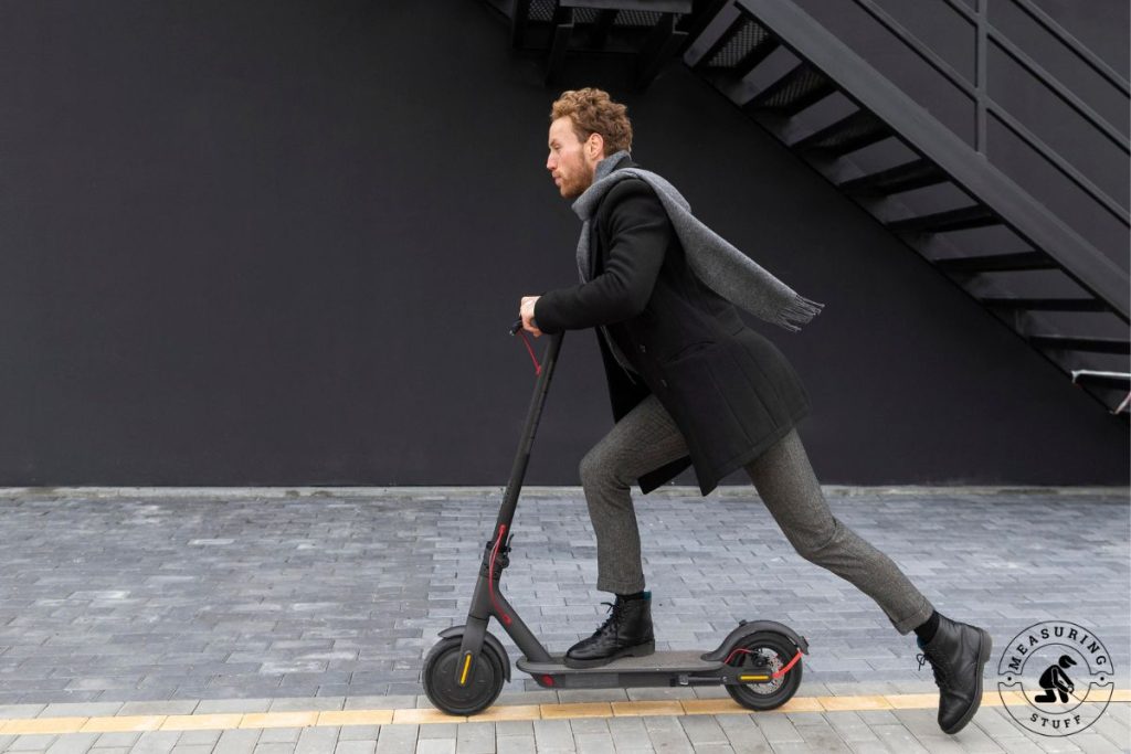 man going fast on an electric scooter