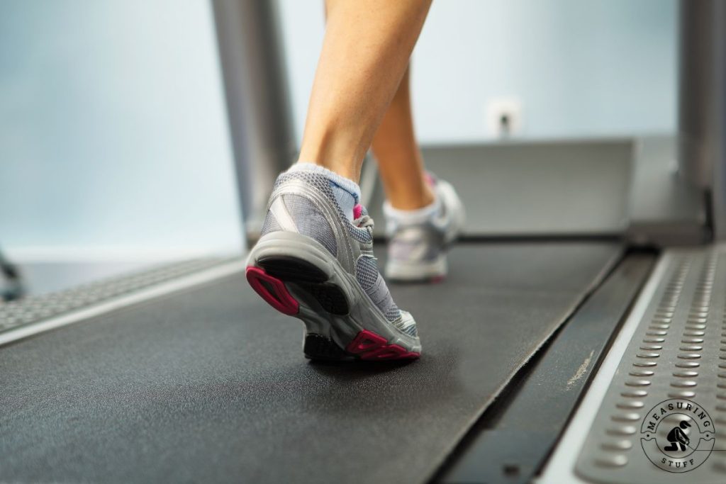 closeup of woman sneakers on treadmill belt