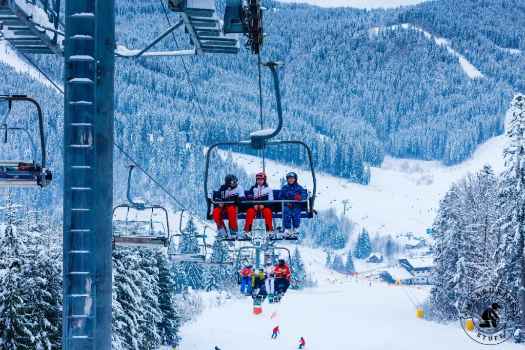 skiers on a ski lift