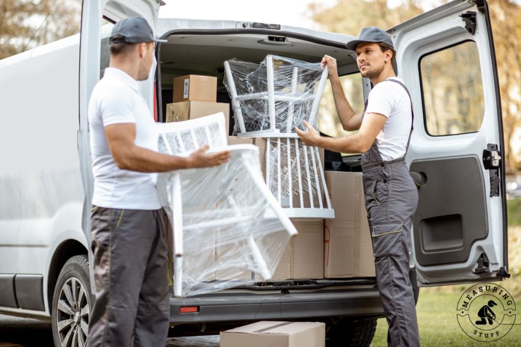 men moving chairs out of a cargo van
