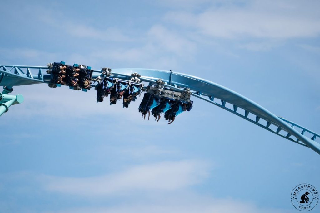 people on a corkscrew roller coaster