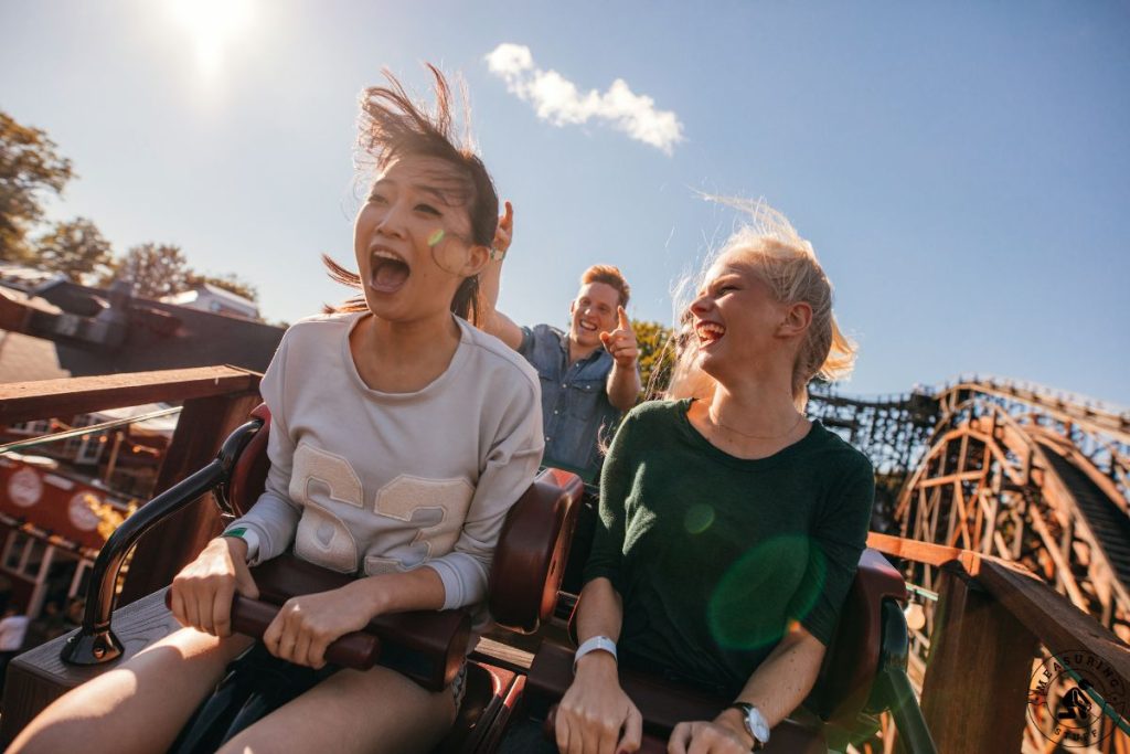 women in front seat of roller coaster