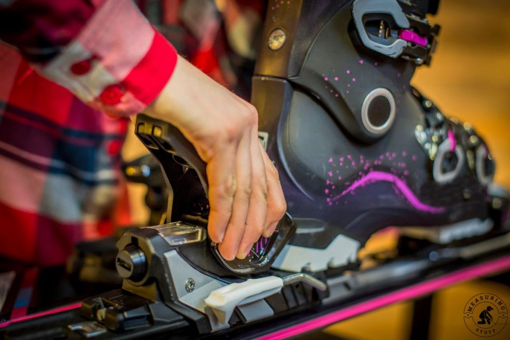 ski binding being mounted to skis