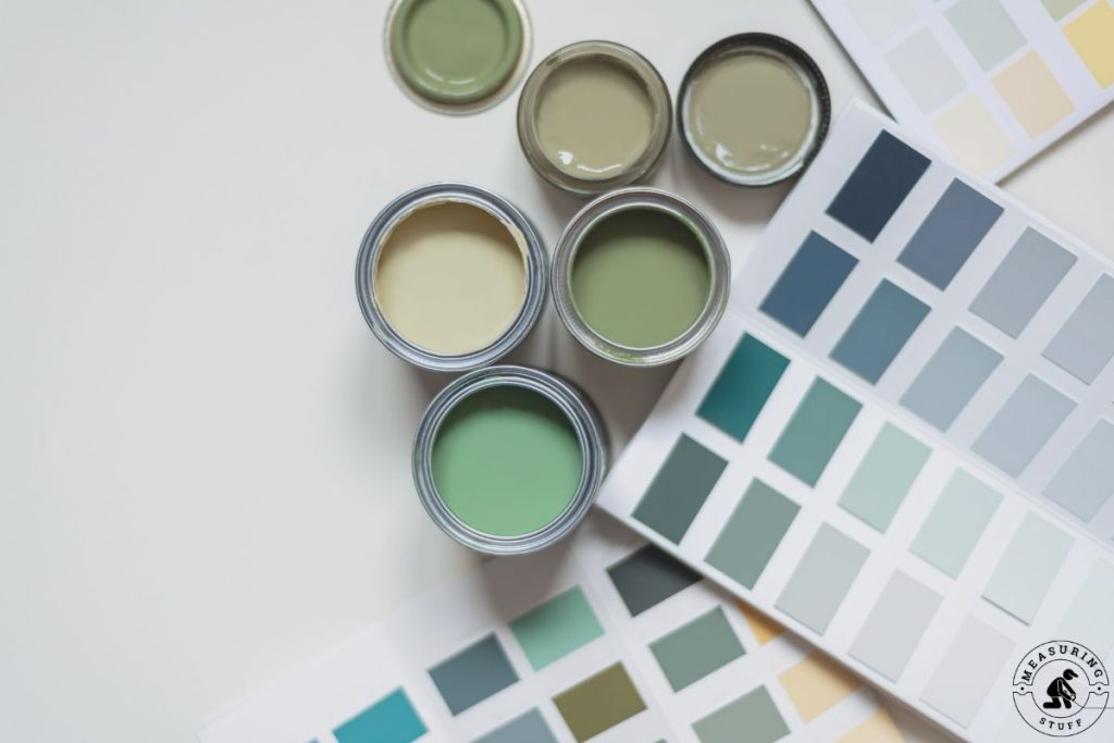 multiple colors of paint in cans with color charts