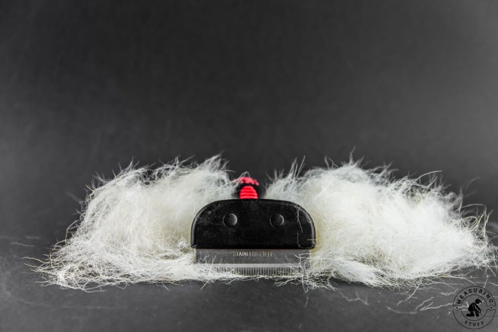 hair removed from a dog using a comb