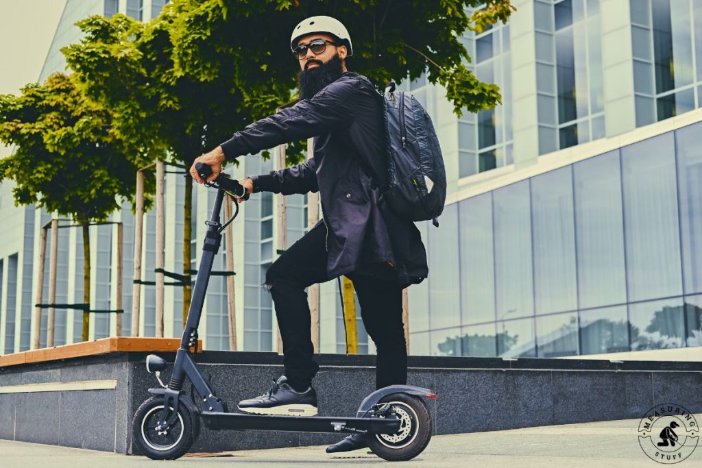 man standing on an electric scooter