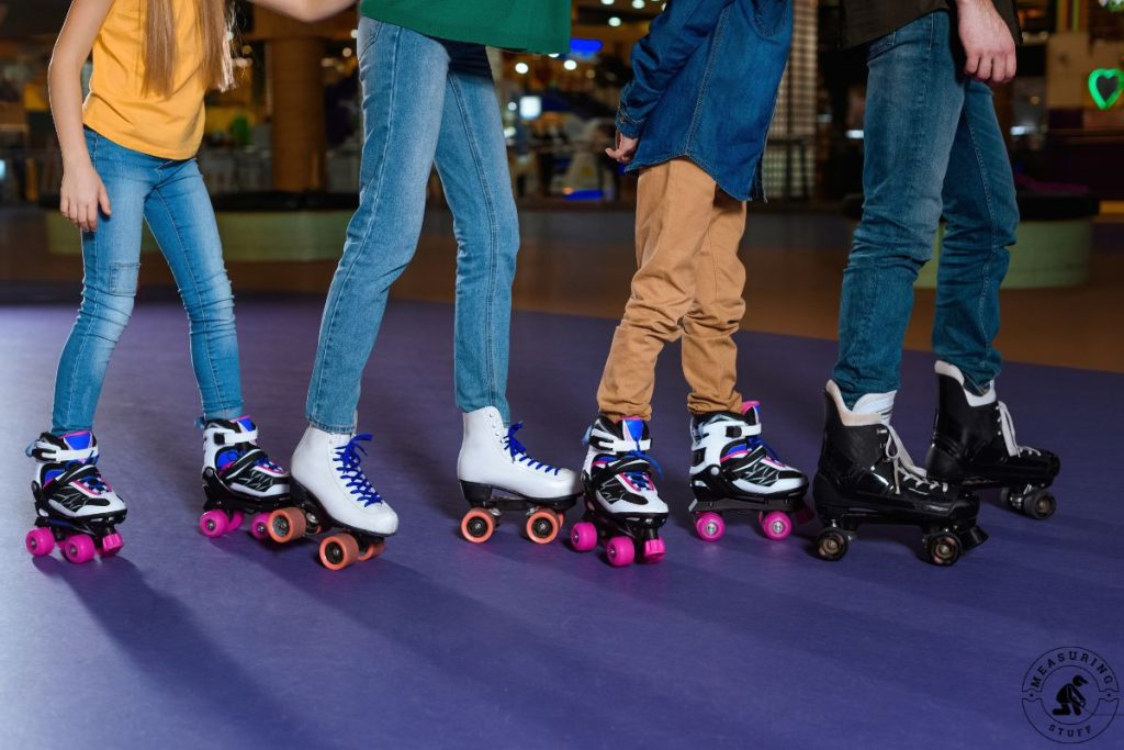 four people roller skating with different style skates