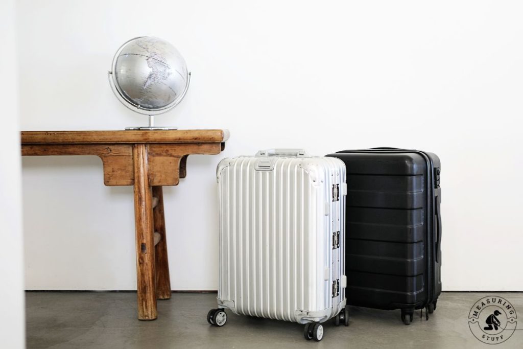 pair of suitcases on wheels next to a table