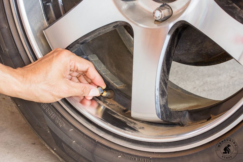 removing valve stem cap from a tire