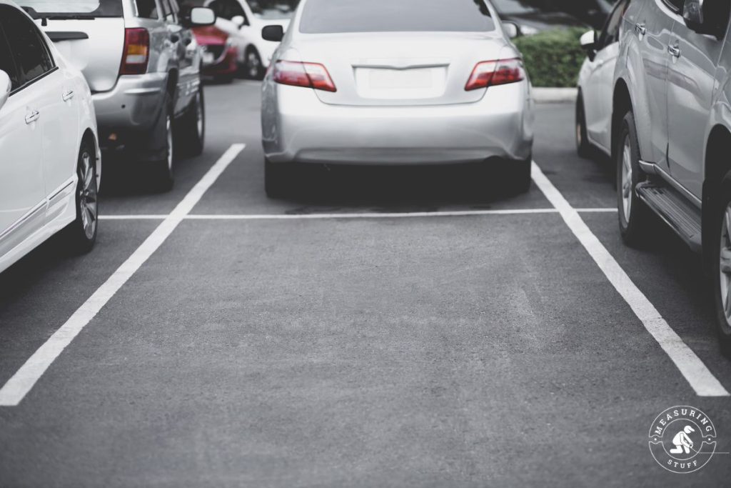 empty parking space surrounded by other cars