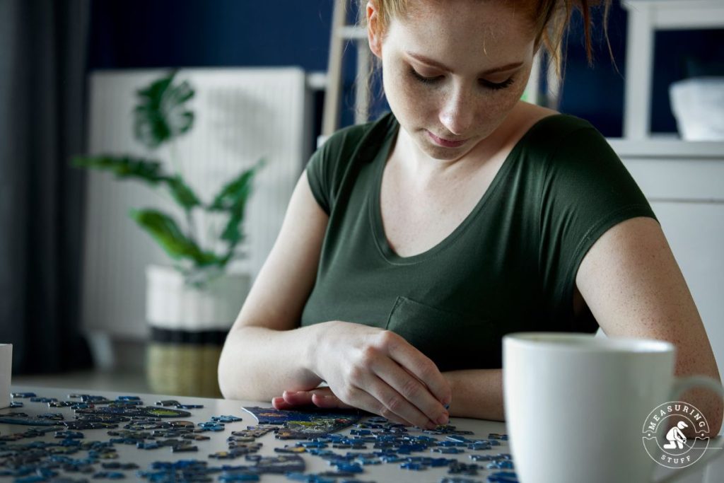 woman putting together a jigsaw puzzle