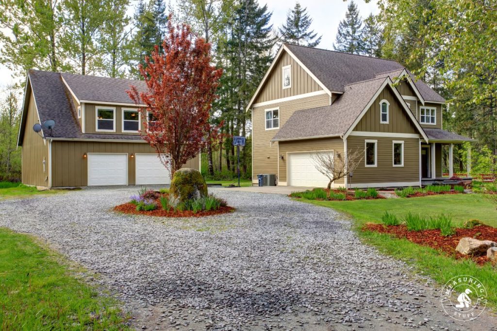 large house with garage and gravel driveway