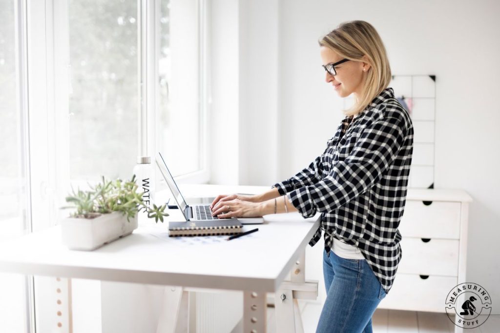 woman using a laptop at a standing desk