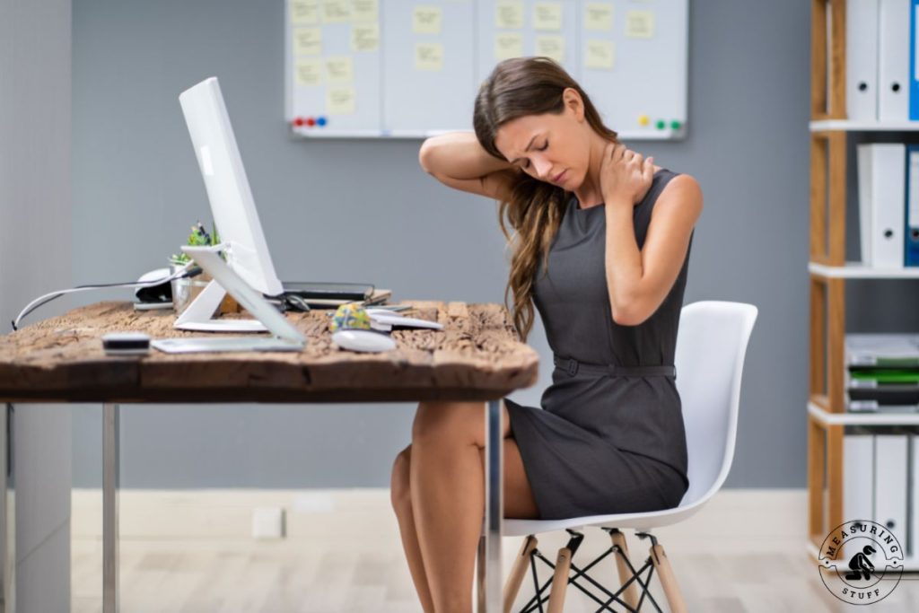 woman sitting at a desk with neck pain