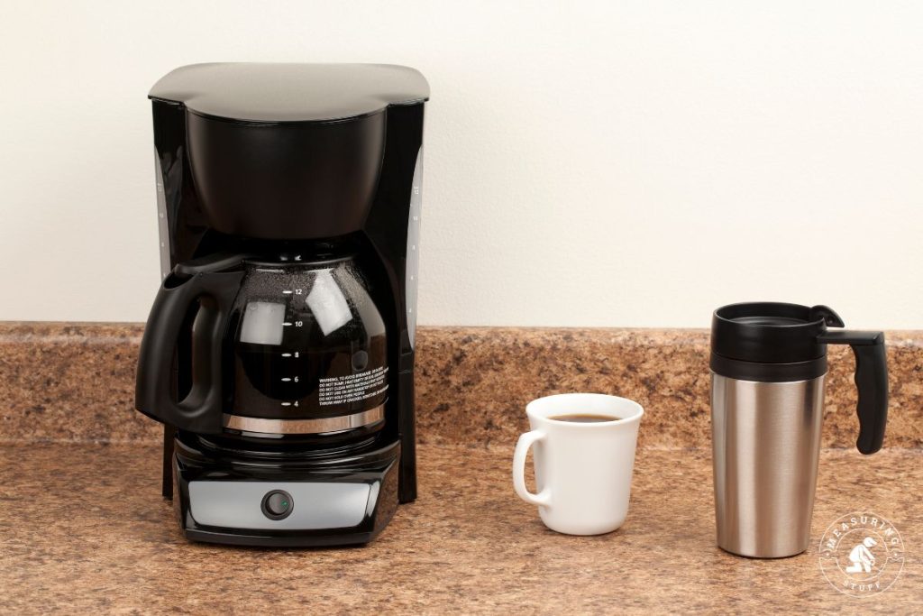 coffee maker with coffee cup and travel mug