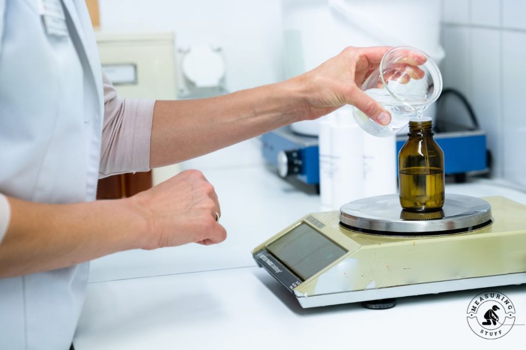 pouring liquid into a bottle on a scale