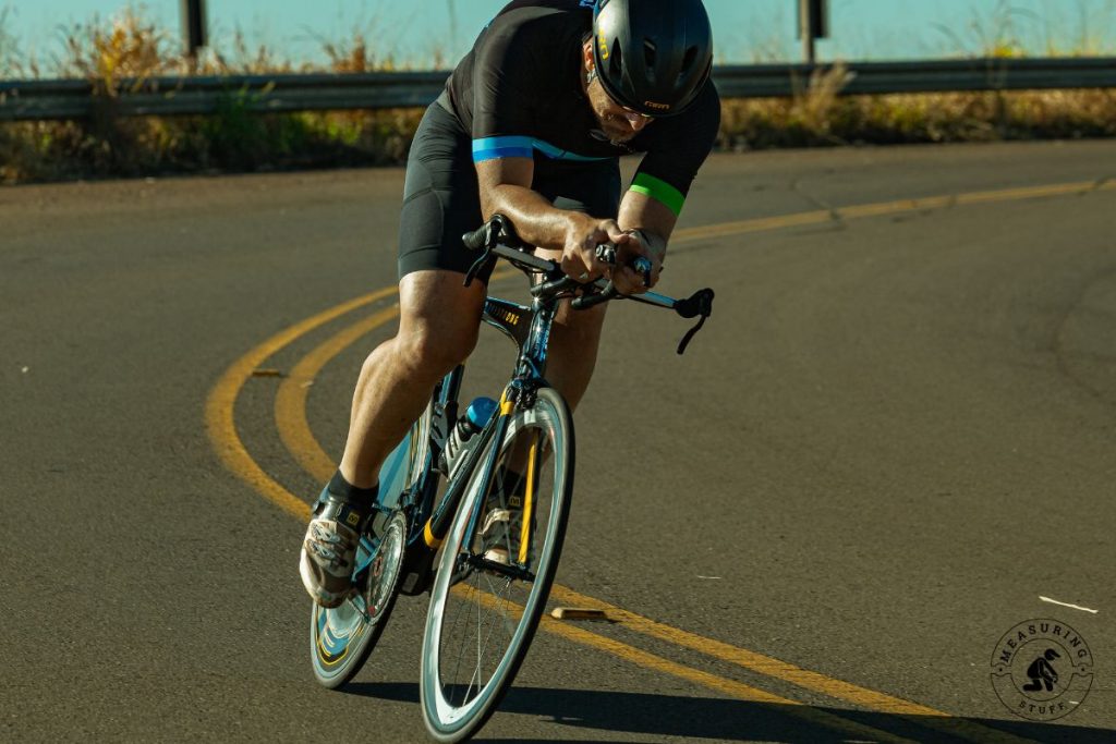man riding a road bike around a turn
