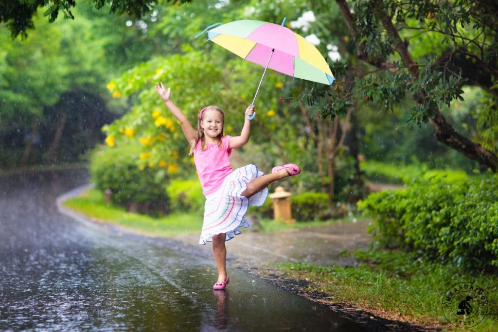 young girl with umbrella in the rain