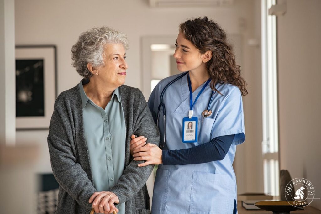 senior woman walking with female nurse