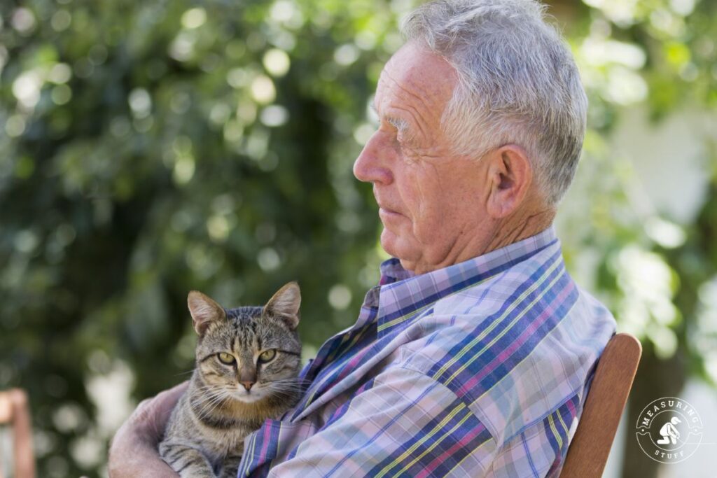 senior man holding a cat