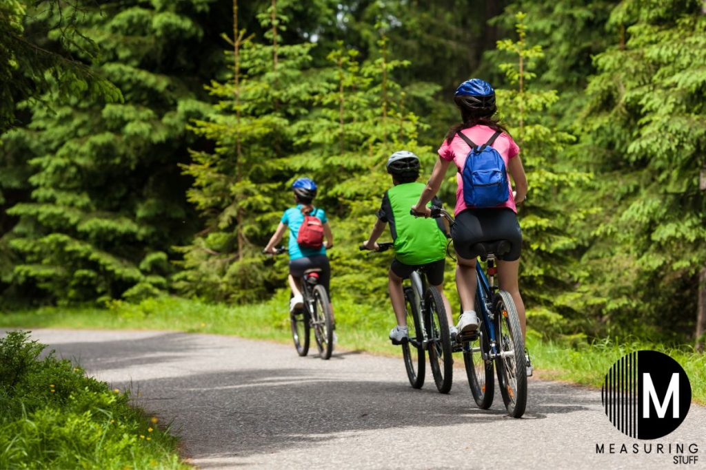 people riding bikes on a path