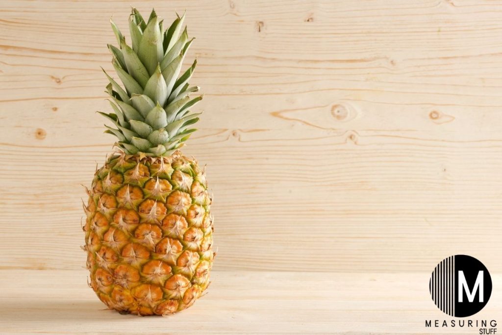 a pineapple on a wooden shelf
