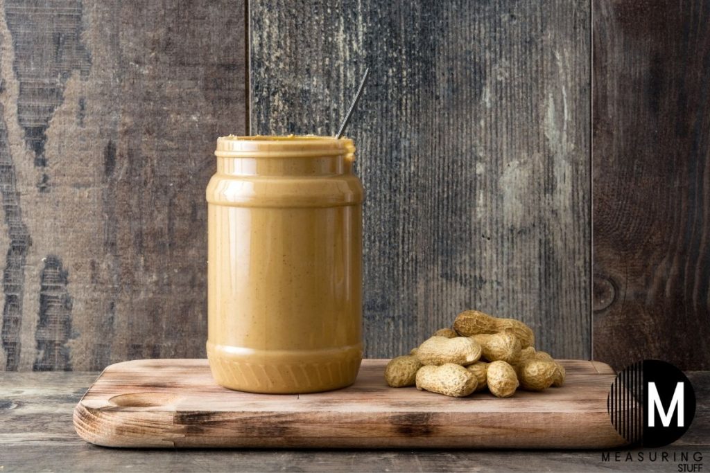 jar of peanut butter on a cutting board
