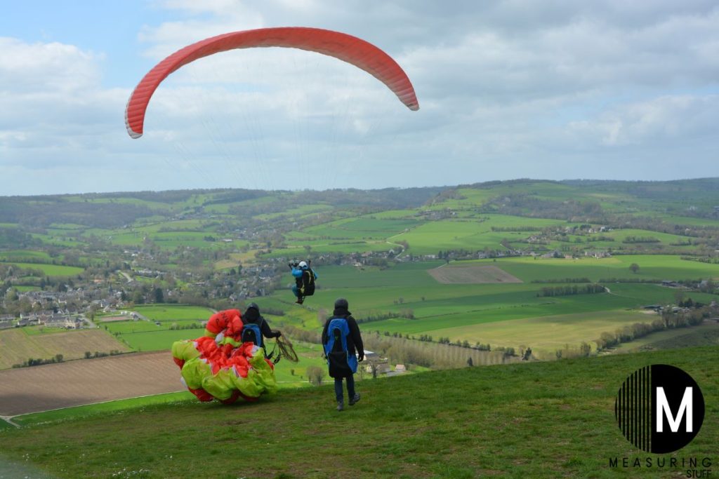paragliders on a hill