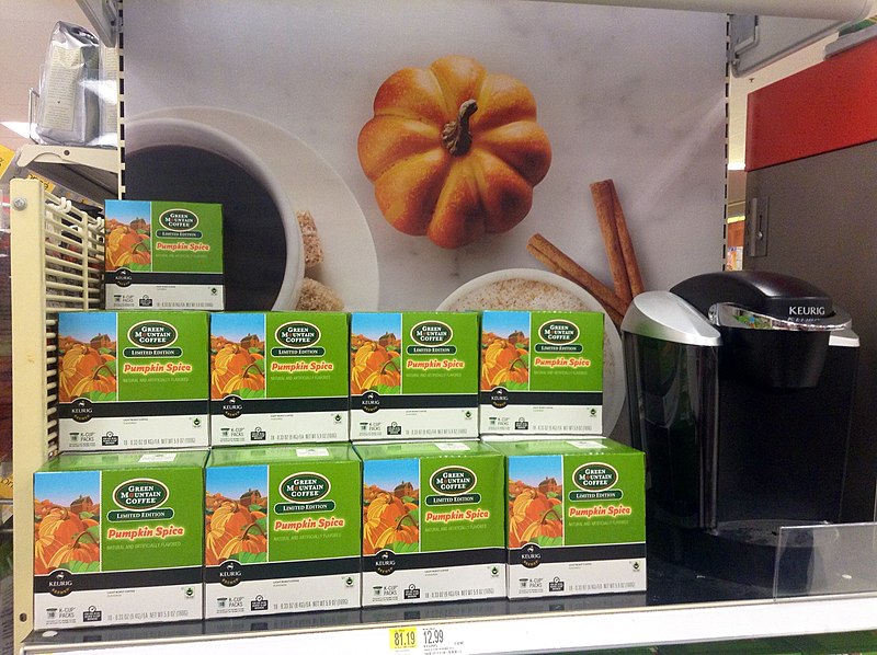 keurig coffee machine with boxes of k-cups on a shelf