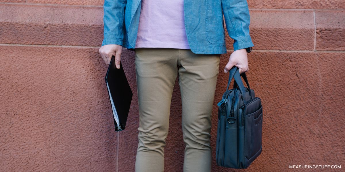 man holding a laptop bag and a binder