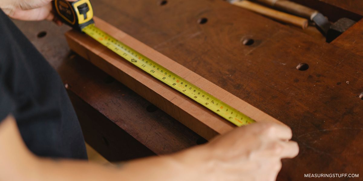 measuring a board with measuring tape