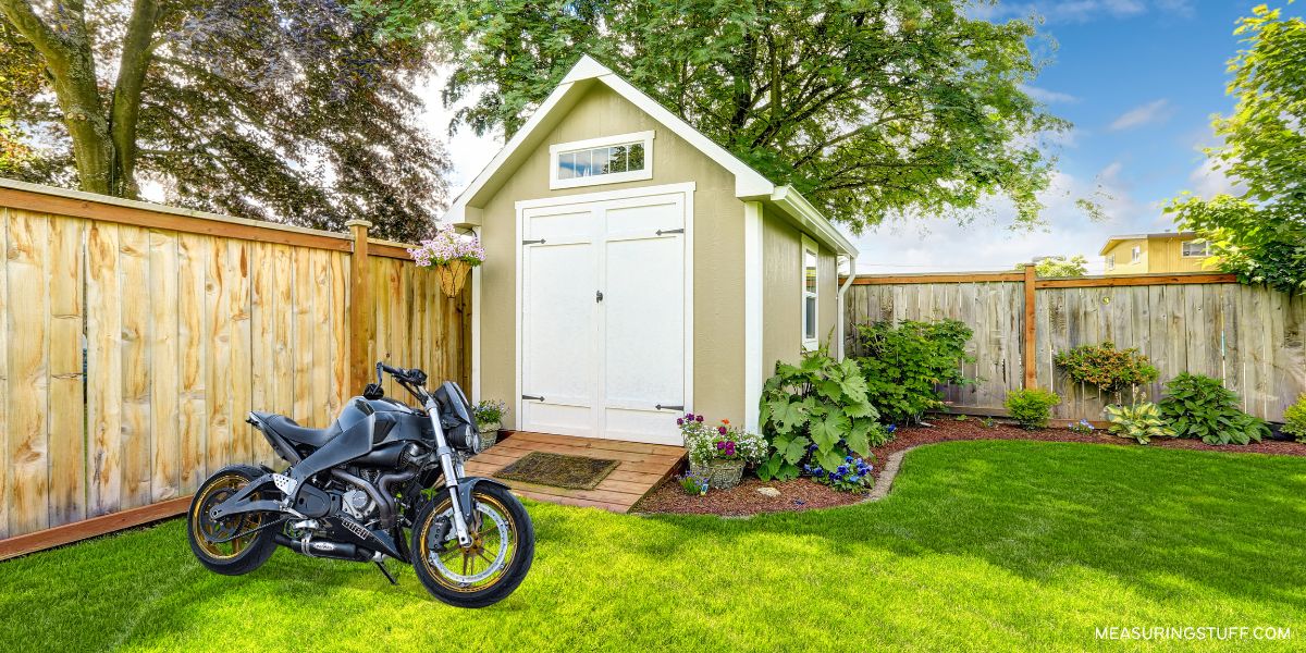 outdoor shed with a motorcycle on the grass