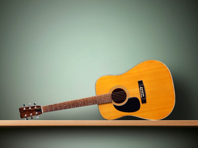 man playing an acoustic guitar