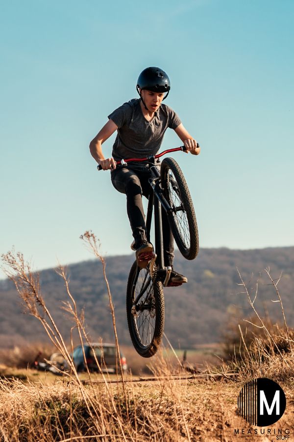 man performing a stunt on a mountain bike