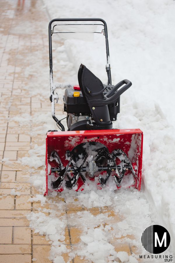 snowblower sitting on a sidewalk