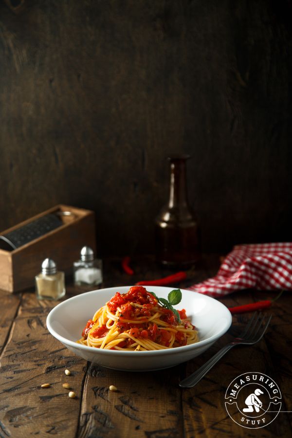bowl of pasta with sauce on a wooden table
