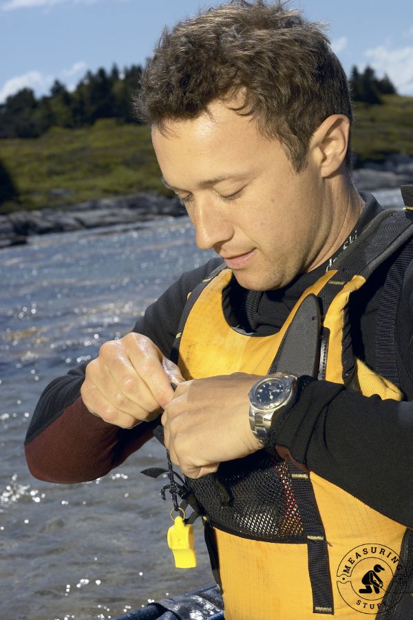 man putting on a life jacket