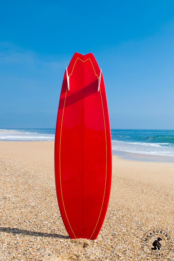 vertical surfboard in the sand