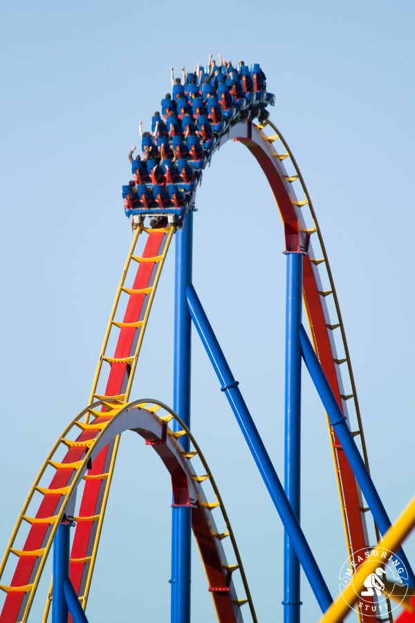 several people at the top of a roller coaster ride