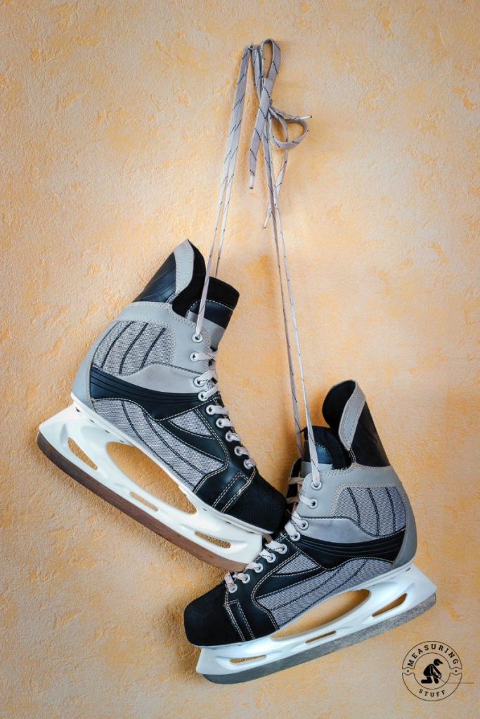 ice hockey skates hanging on a wall