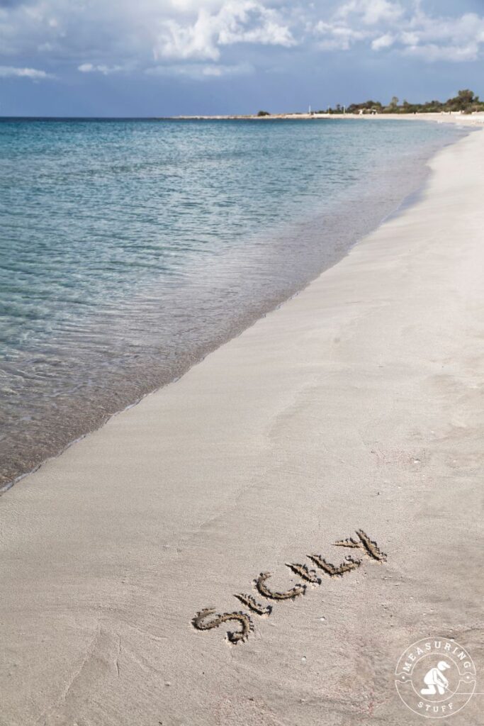 Sicily written in sand on a beach