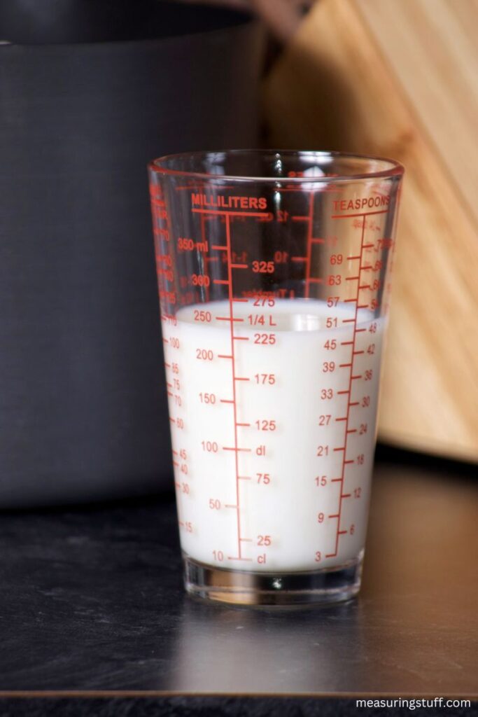 tall glass of milk showing milliliters