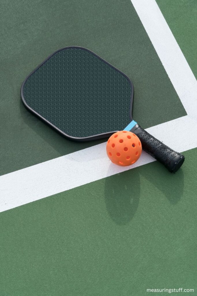 pickleball paddle with orange ball