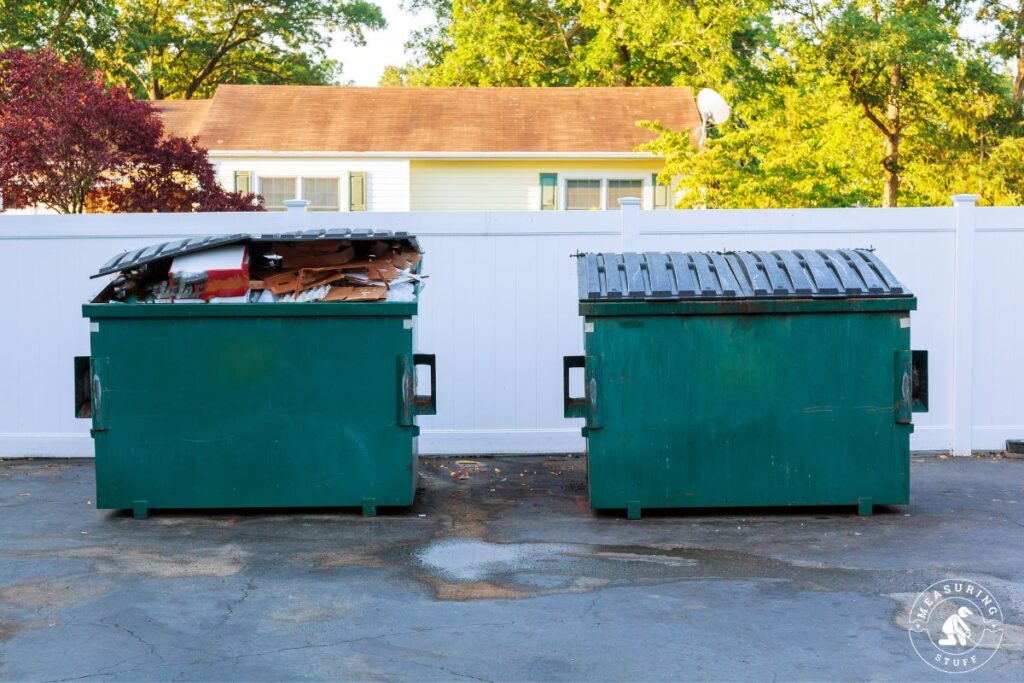 pair of green dumpsters