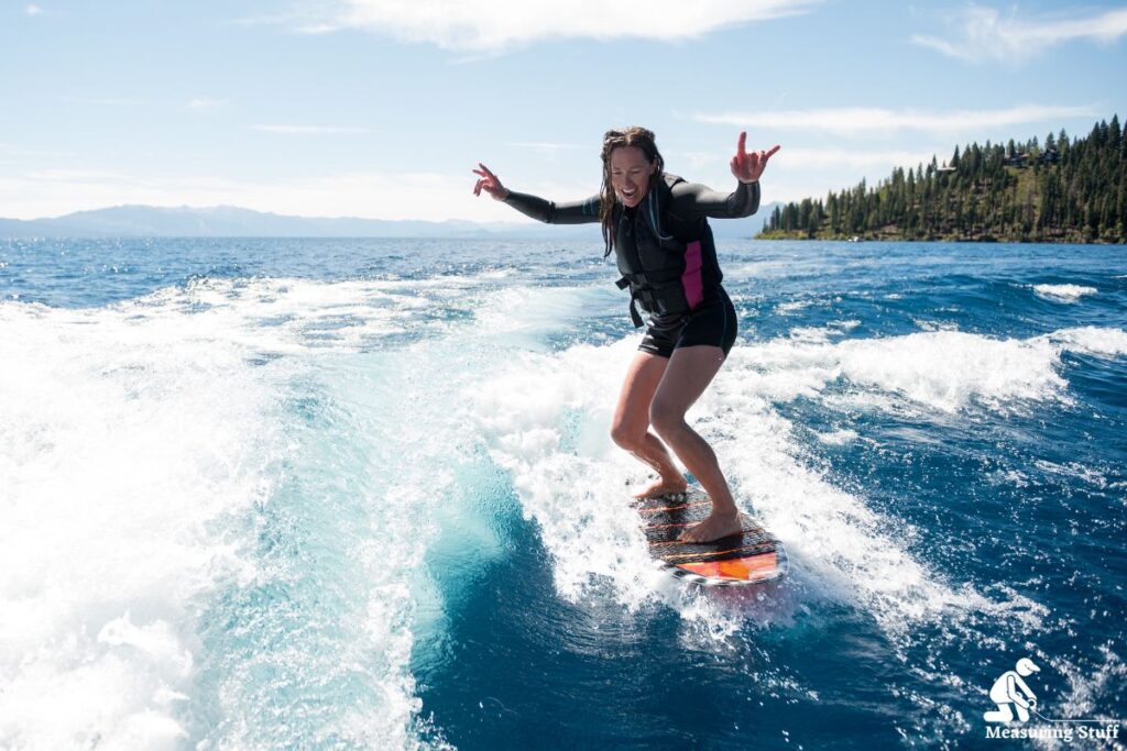 woman wakesurfing on clear blue water