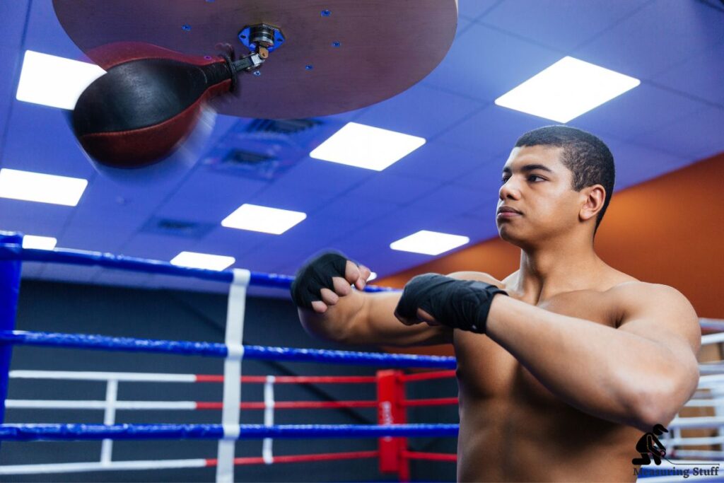 man using a speed bag in a gym