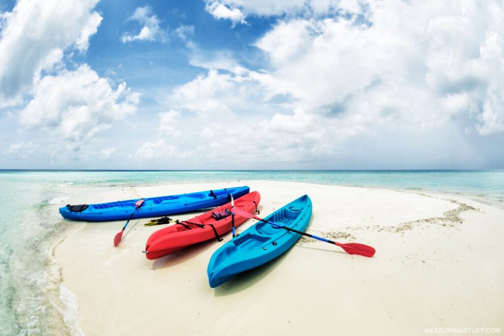 trio of kayaks sitting on the sand