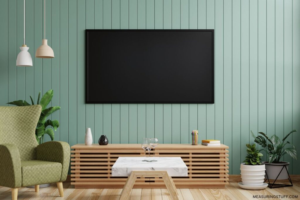 mounted smart tv on a green wall